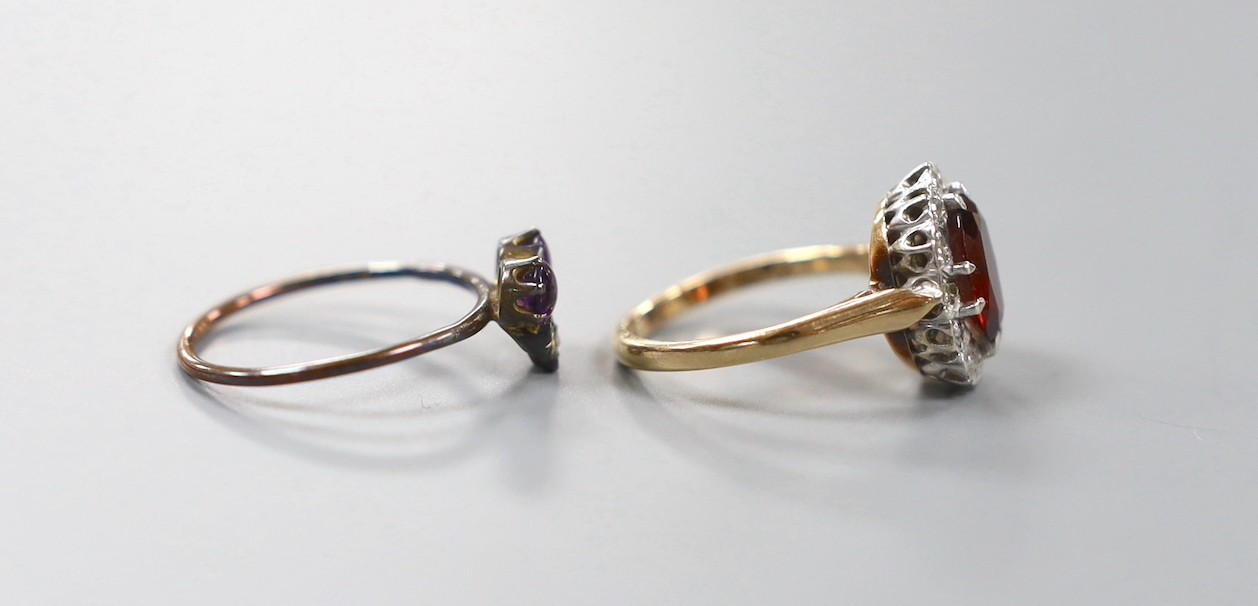 A continental yellow metal, garnet and diamond chip set oval cluster ring, size K and a small Victorian yellow metal, two stone cabochon amethyst and three stone rose cut diamond set cluster ring, size M, gross weight 4.